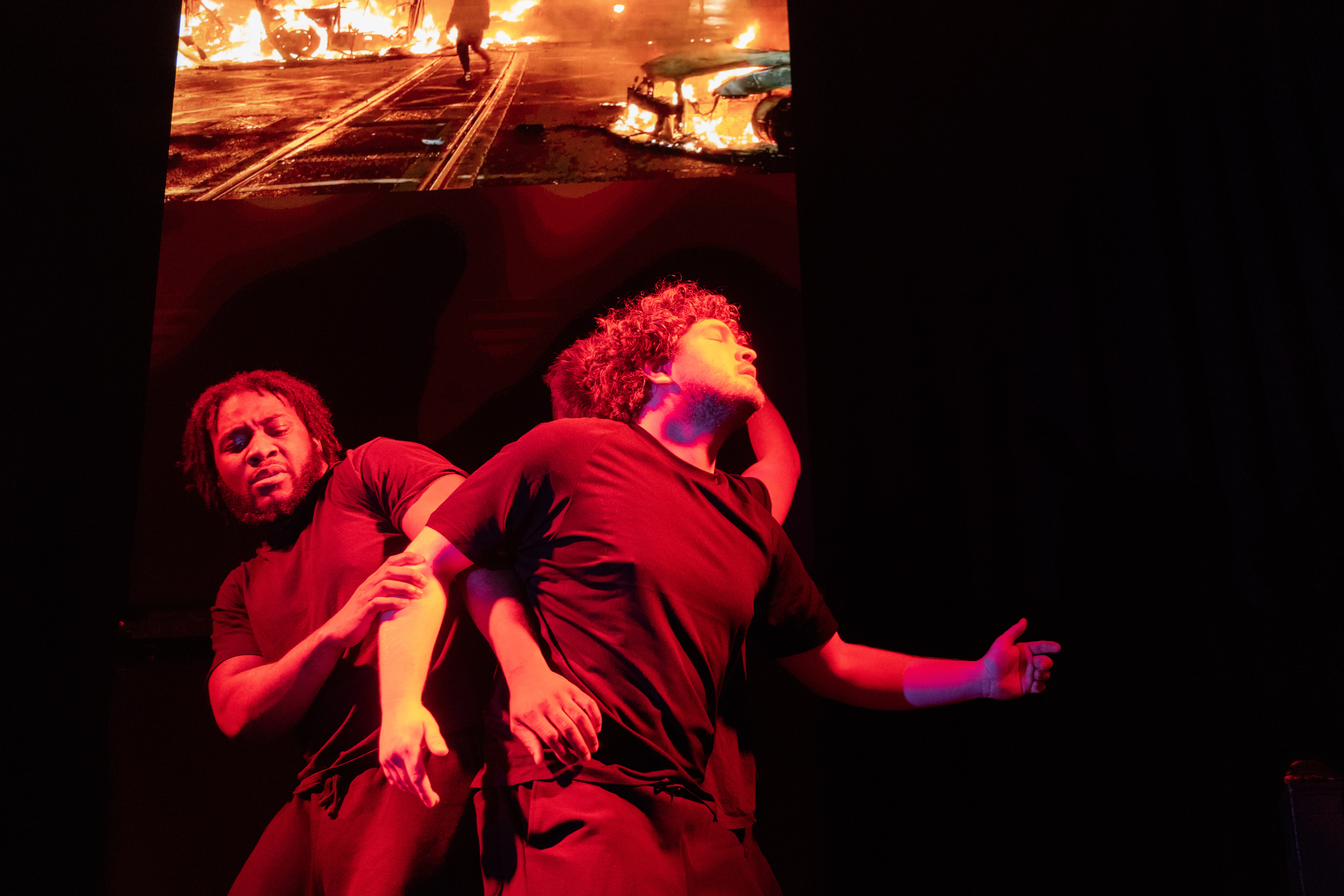 Actors moving in red light - SUPPLIANTS OF SYRIA